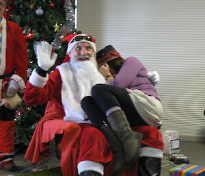 A female expeditioner sitting on Santa’s knee