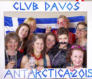 A portrait photo of nine girls all dressed up for New Years Eve