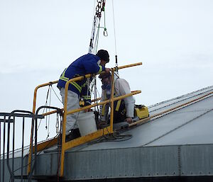 Expeditioner being lowered into the tank through a small opening
