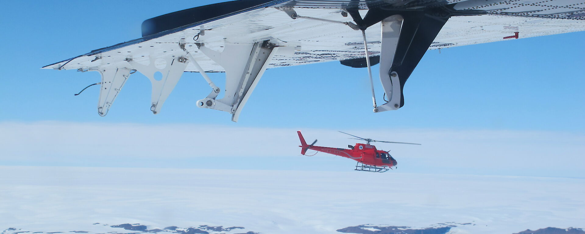 A flying helicopter photo taken from another aircraft