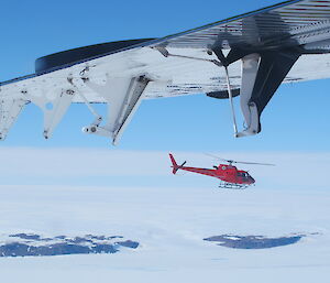 A flying helicopter photo taken from another aircraft