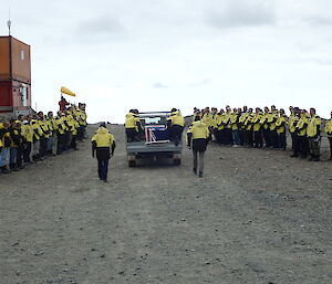 Line of honour as a ute containing a coffin drives past