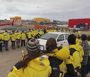 A line of honour as a casket passes in a vehicle