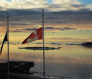 Australian and Canadian flags at half mast