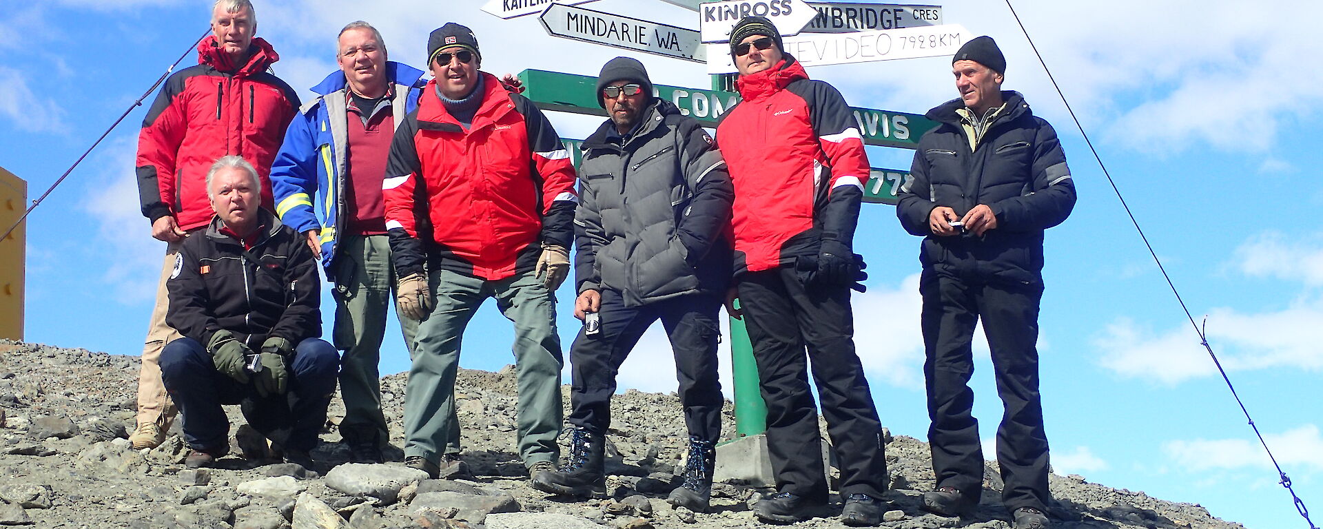 Seven expeditioners pose for a photo at Davis