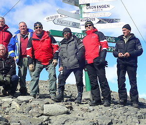 Seven expeditioners pose for a photo at Davis