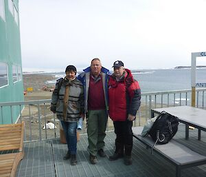 Davis station leader with two Russian expeditioners pose for a photo