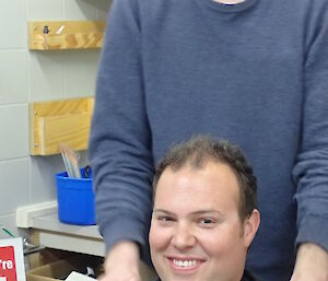 Two expeditioners pose before getting a haircut