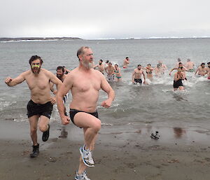 An expeditioner leaving the cold water after the swim
