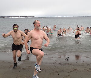 An expeditioner leaving the cold water after the swim