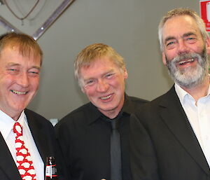 Three male expeditioners in suits ready for dinner