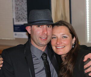 A male and female expeditioner pose for a photo on formal night