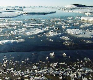 Stunning white rafts of sea ice in the dark waters of the bay in front of Davis station