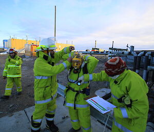 Four members of the Davis fire team in protective clothing carrying out an exercise at Davis Station
