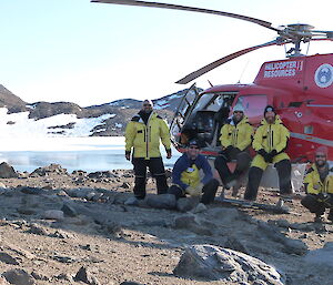 Five expeditioners next to one of the B3 helicopters used for logistics work by the AAD