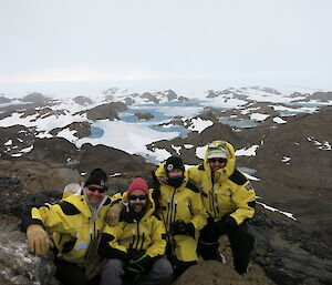 A group of 2015–2016 Davis expeditioners on top of Stalker Hill in the Vestfold Hills with the ice plateau in the background