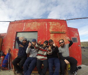 Five summer expeditioners from Davis at Brookes hut acting silly for the camera