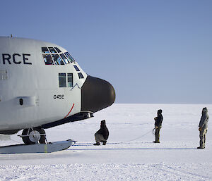 The crew of the LC130 in front of the cockpit of the aircraft checking for the flight from Davis to McMurdo