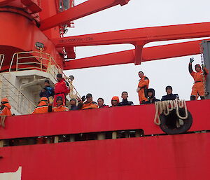 Chinese expeditioners on the Xue Long wave from the deck