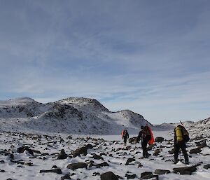 Hikers in the snow-covered Vestfold Hills make their way back to Davis Station