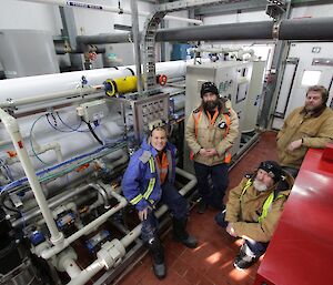 Vas Georgiou, Darren White, Paul Deverall and Scott Visserin the tarn building with the reverse osmosis plant, lots of pipes and cables around but very tidy