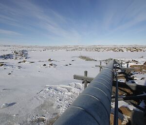 Pipeline to the now frozen tarn is rather large, outdoor, and elevated — surrounded by snow