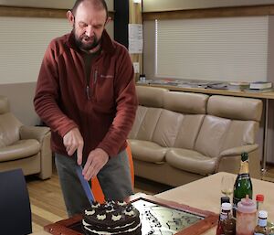 John Parker slicing up his birthday cake at Davis