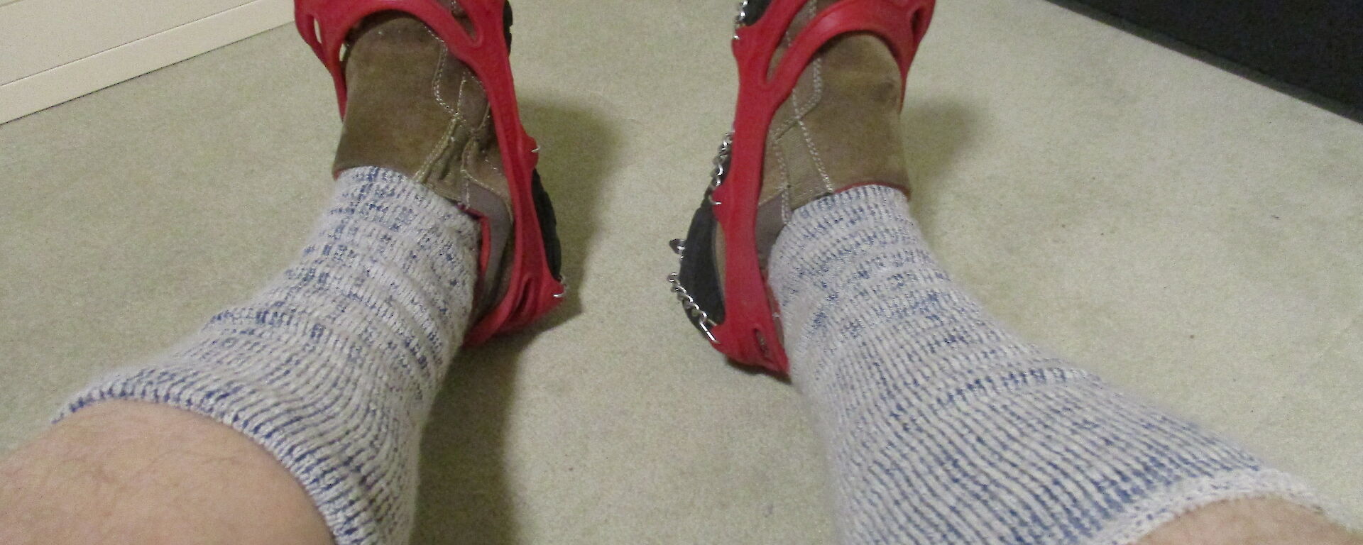 A pair of summer sorrells with spiked chains on sock covered legs