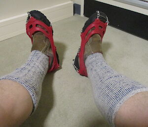 A pair of summer sorrells with spiked chains on sock covered legs