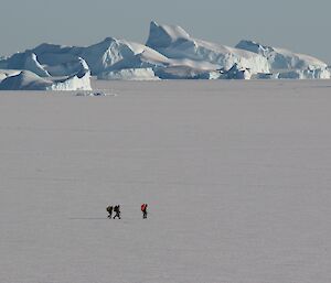 Ladge Kviz, Chris Burns and Ali Dean on the sea ice in front of Davis Station