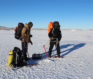 Chris Burns and Ladge Kviz test the sea ice thickness on the sea ice in front of Davis Station