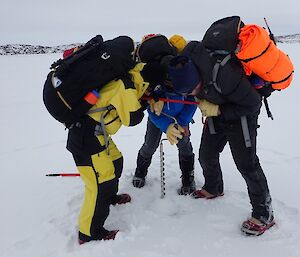Aaron Stanley, Chris Burns and Scott Burns drilling the sea ice in front of Brookes hut