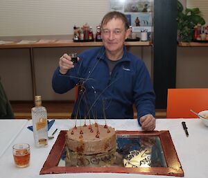 Dave Davies in front of his cake in the dining room at Davis