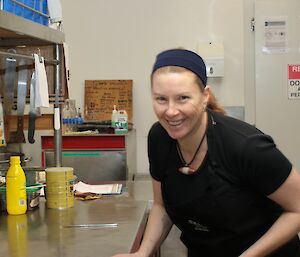 Lesley Eccles, Davis Chef Winter 2016, smiles for the camera in the kitchen while wearing her chef’s uniform