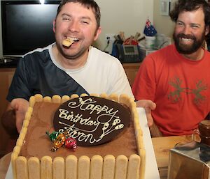 Aaron Stanely takes a bite of one of the sponge-fingers from the side of his ice-cream birthday cake