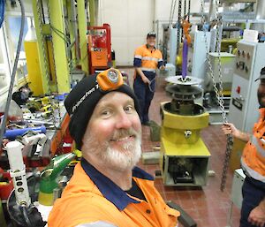 Expeditioners changing out a bearing in the alternator in the main power house at Davis