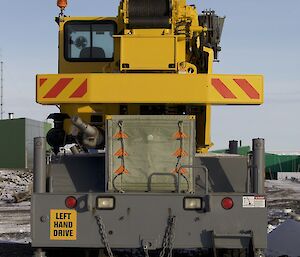 Back of the crane with blizzard cover over radiator and cap on the exhaust pipe parked back into the prevailing wind at Davis for the winter