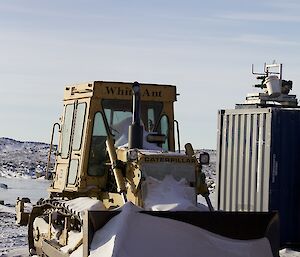 D6 dozer with snow banking up on it, parked at Davis for the winter