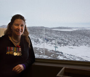 Lesley Eccles wears a line of medals belonging to her father at Davis on ANZAC Day
