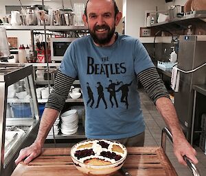 John Parker stands proudly behind his trifle decorated in the Wessex colours