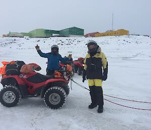 Darren White and John Parker with quad bikes on the sea ice in front of Davis Station
