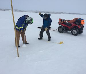 Ladge Kviz drilling the sea ice and Darren White getting the tape ready to measure the sea ice thickness