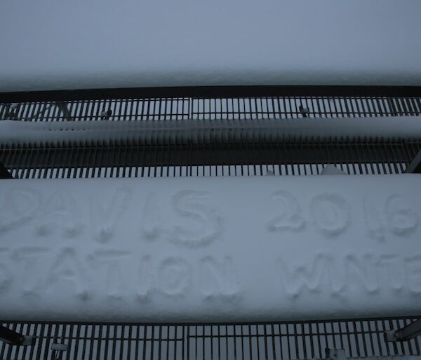 Seat on the balcony at Davis topped with fresh snow that then has ‘Davis Station 2016 Winter’ written on it