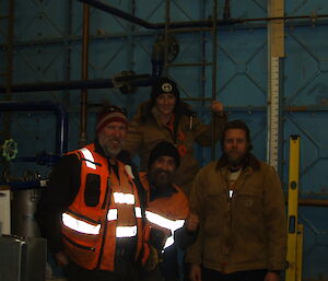 Michael Goldstein, Jen Proudfoot, Darren White and Scott Visser in front of the water tank they have just cleaned at Davis
