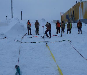 View from the Hägglunds of the sea ice recovery system set up, with Jen Proudfoot pulling the tifor handle to winch the Hägglunds in a recovery exercise at Davis station