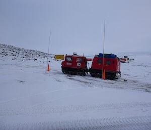 Driving a Hägglunds through a slalom course set up on the beach at Davis