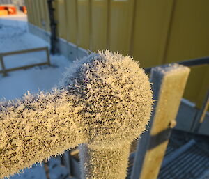 A close-up view of the ice needles on a hand rail at Davis