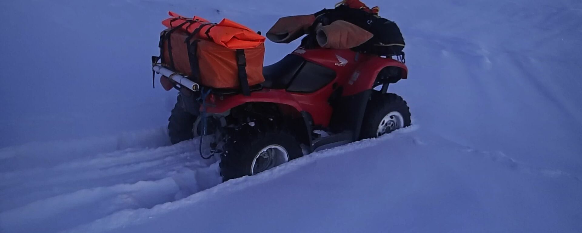 Darren Whites quad bike stuck in deep snow in the tide crack area while attempting to travel onto the sea ice at Davis