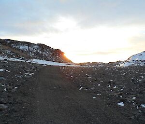 Sun poking out from behind the hill at Pioneer Crossing, one of the very few land crossings in the Vestfold Hills