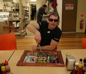 Brett Sambrooks cuts his birthday cake at Davis